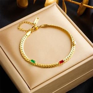 Gold plated snake chain bracelet with colored zircons on a luxury display