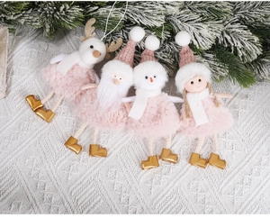 Close-up of pink plush Christmas ornaments set including reindeer and Santa on white knit