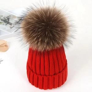 Winter chunky red knit beanie hat with a large fluffy brown faux fur pom pom