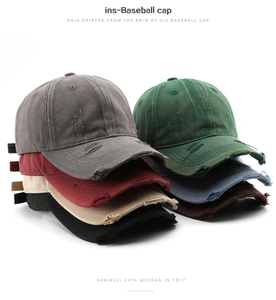 Macro view of vintage distressed baseball caps showing washed cotton fabric and ripped details