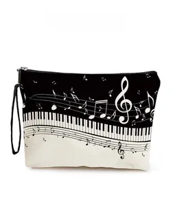Detail of piano keyboard and musical notes print on portable zipper cosmetics organizer bag
