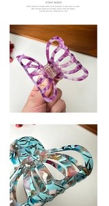 Detail of purple butterfly acetate hair claw and teal terrazzo pattern shark hair clip