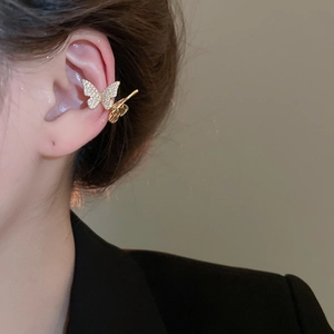 Detailed view of a gold-plated butterfly ear cuff with sparkling zircon inlay for women