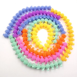 Macro shot of colorful caterpillar sensory fidget toy with rainbow soft spikes and tentacles