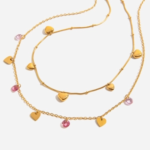 Double-layer 18k gold plated necklace with heart pendants and pink crystals on white base