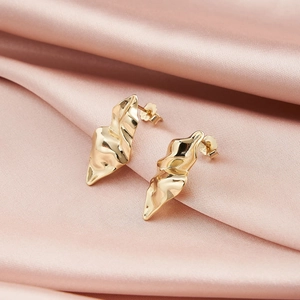Detailed view of irregular gold metal earrings with S925 sterling silver stamp