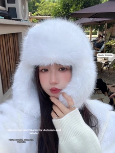 Detail view of the soft white faux fur texture and ear protection design on winter ushanka