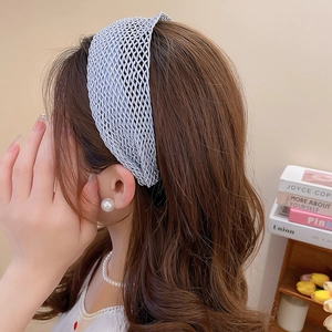 Detail of grey-blue woven headband with hollow mesh craft on a female model