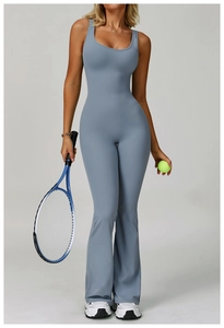 Detailed full-length view of high-waist flared yoga jumpsuit in smokey blue performance fabric