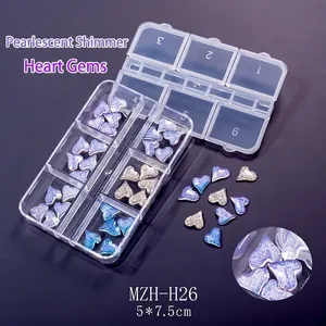 Close-up of heart-shaped glitter nail art rhinestones in a 6-grid organizer box