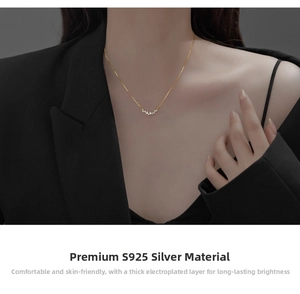 Detail of S925 sterling silver gold-plated necklace with zircon stones on a model