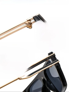 Detail of durable gold metal hinges and black frame on modern rock style sunglasses