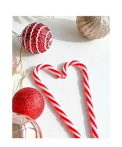 Detail of candy cane heart and multi-finish Christmas ornaments in festive red and gold