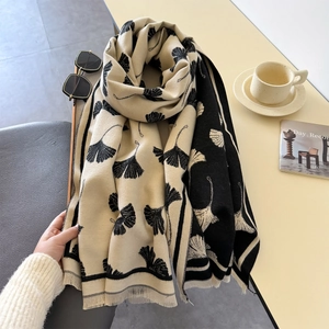 Detail of soft ginkgo leaf jacquard scarf with delicate fringe edges and thick texture