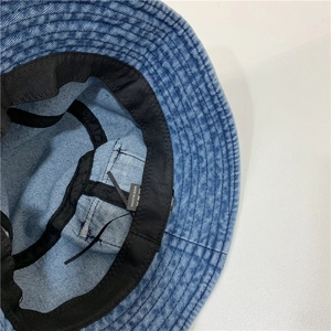 Detailed view of the denim bucket hat interior showing stitching and black sweatband