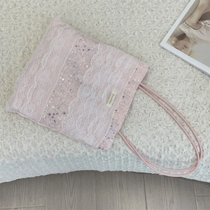 Close-up of floral lace overlay with silver sequins and beads on the pink tote bag