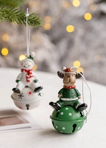 Close-up of decorative Christmas bells with snowman and reindeer patterns and red ribbons