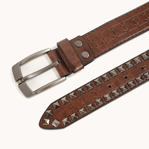 Vue détaillée d'une ceinture en cuir marron vintage avec boucle métal et rivets.