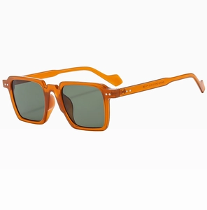 Detail of amber square sunglasses with dark green lenses and silver metal rivets
