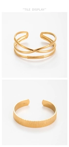 Detail display of textured golden stainless steel open bangles with hammered patterns