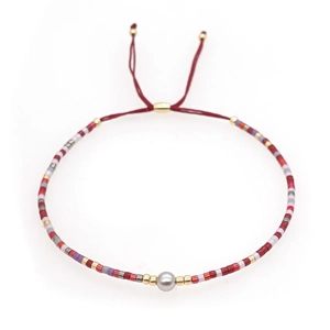 Bohemian handmade beaded bracelet with colorful stones and adjustable red cord strap