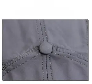 Macro shot of grey baseball cap top showing fabric texture and matching fabric button