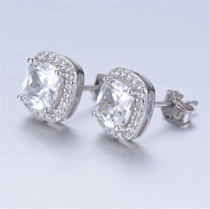 Macro shot of silver square earrings with large clear zircon and micro-pave crystals