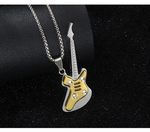 Detailed view of silver guitar pendant with gold accents and four sparkling rhinestones