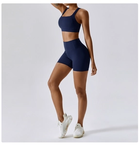 Detail of high-waist slimming dark blue yoga shorts and high-impact sports bra set