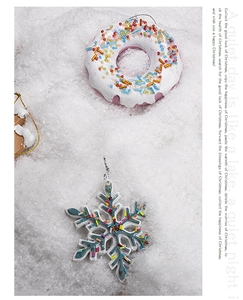 Festive resin Christmas ornaments with donut and snowflake designs on a snowy background