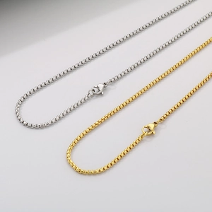 Detail of silver and gold stainless steel box chains with secure lobster clasps