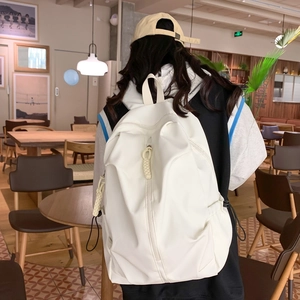 Minimalist white large capacity backpack shown from the back view on a model