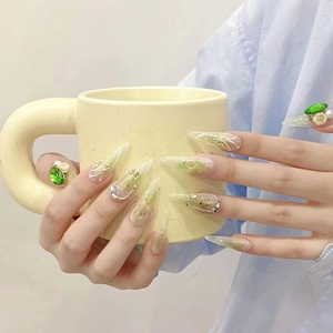 Handmade green butterfly press-on nails with 3D emerald gems and gold foil details