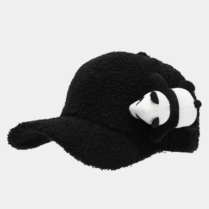 Close-up of black fuzzy sherpa baseball cap with a cute panda plush ornament detail