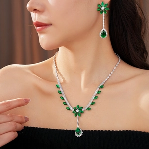 Detail of luxury zircon flower jewelry set featuring emerald green teardrop necklace and earrings