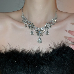 Close-up of floral water drop crystal necklace set with silver finish on model