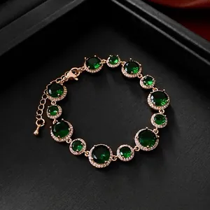 Vintage gold plated bracelet with emerald green zircons and sparkling halo settings
