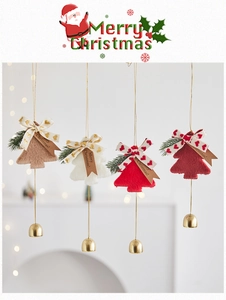 Detail of plush Christmas tree ornaments with festive bows, bells and Kraft tags
