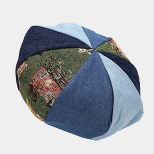 Detail of vintage patchwork beret featuring blue denim and jacquard fabric textures