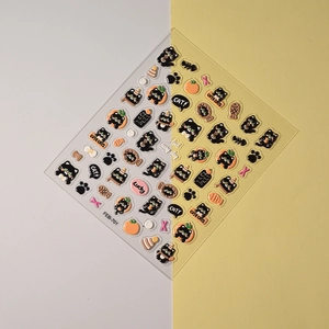 Detail of 3D embossed black cat and fish bone nail stickers with glossy finish