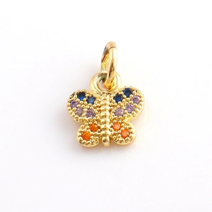 Detailed view of a gold butterfly charm with colorful zircon stones for DIY jewelry making