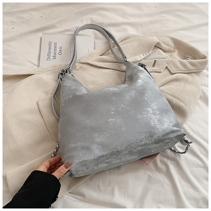 Detail of silver grey tote bag showing metallic texture and vintage chain straps