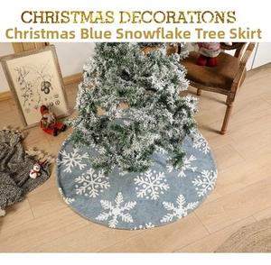 Light blue plush Christmas tree skirt with white snowflake patterns and matching stocking