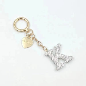 Detail of crystal letter K keychain with I Love You heart tag and golden chain clasp