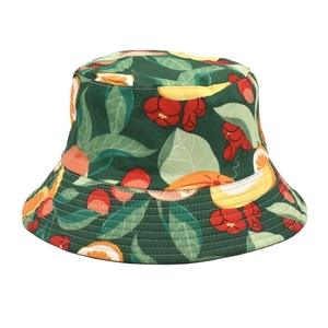 Close-up of deep green bucket hat featuring vibrant cherry and citrus fruit prints