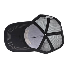 Close-up of black trucker hat interior showing white mesh structure and laundry label