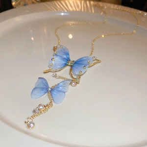 Detail of tulle butterfly necklace with pearls and rhinestones on gold chain