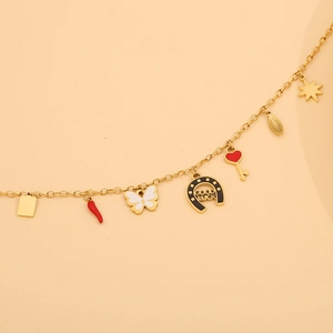 Detail of gold chain necklace featuring colorful horseshoe star and heart charms