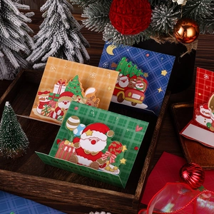 Detail of 3D pop-up Christmas cards featuring Santa and reindeer on a rustic tray