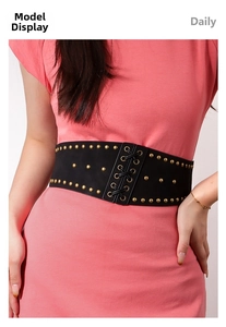 Detail of black corset belt with gold studs and lace-up design for women waist styling